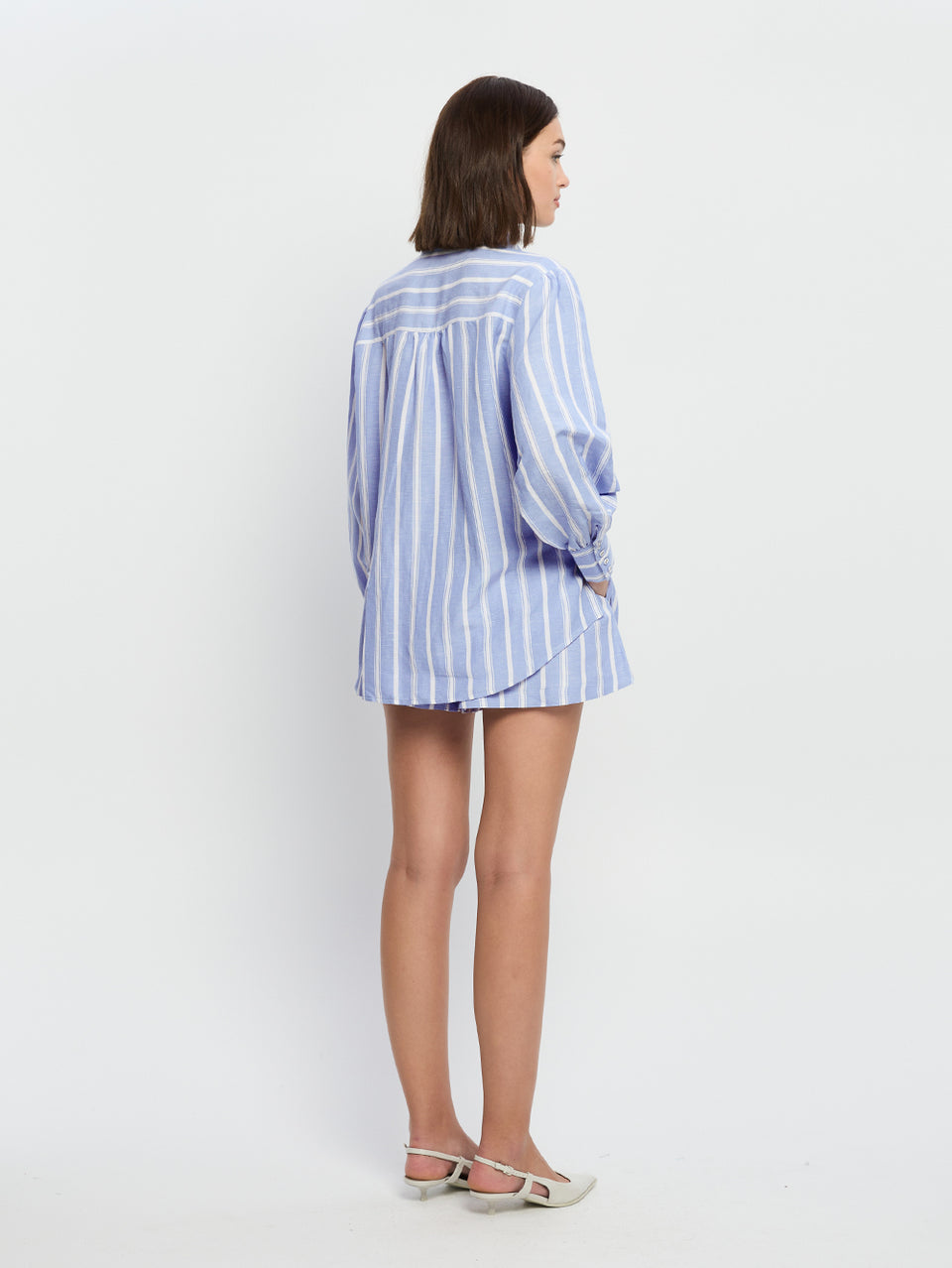 Capri Shirt KIVARI | Model wears blue and white stripe shirt back view
