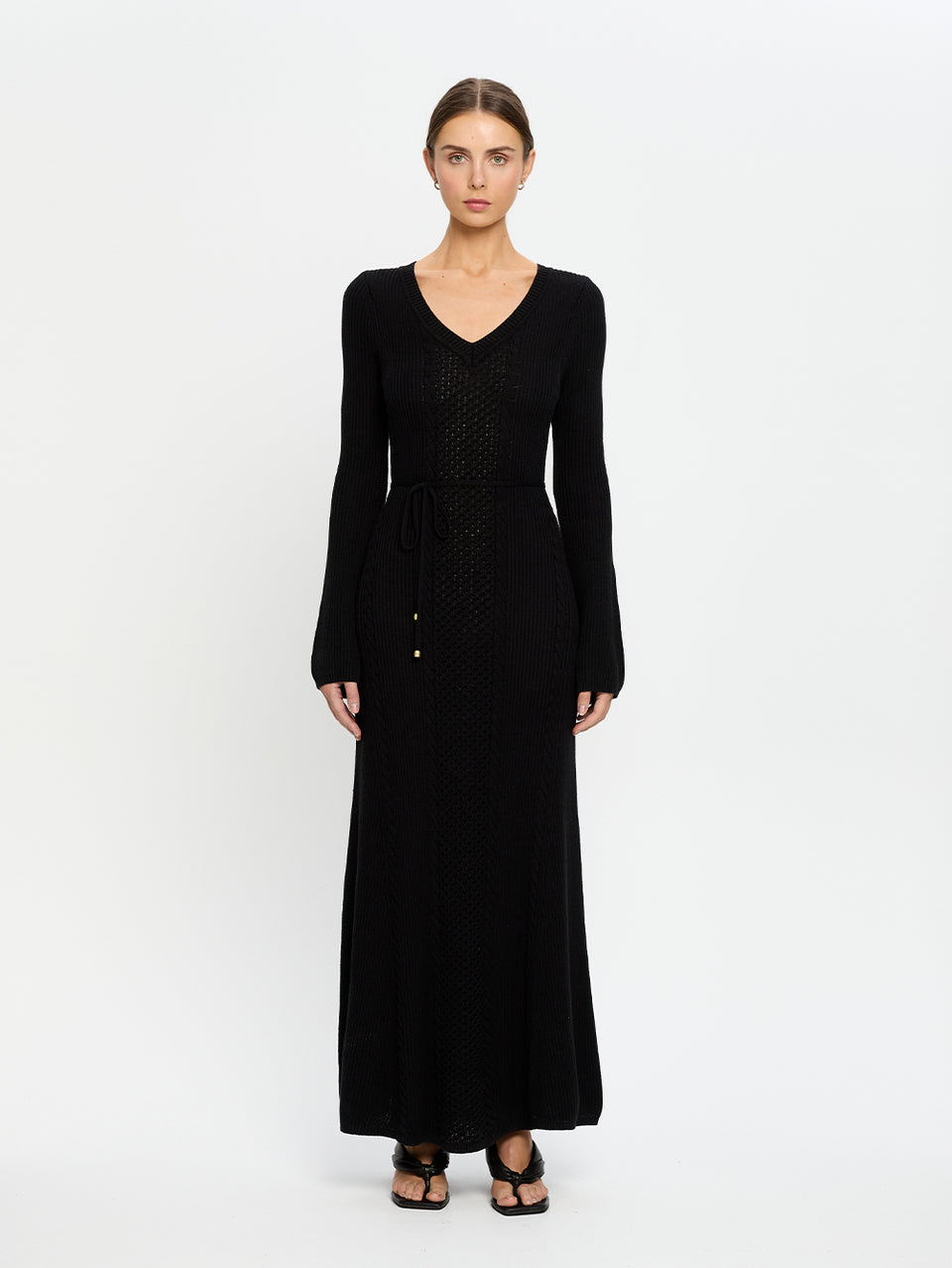 Woman wearing a black dress on a white background