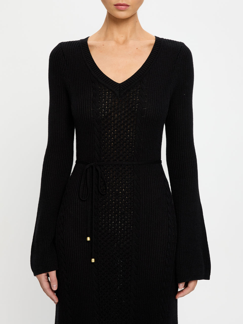 Black ribbed knit dress with a belt on a white background