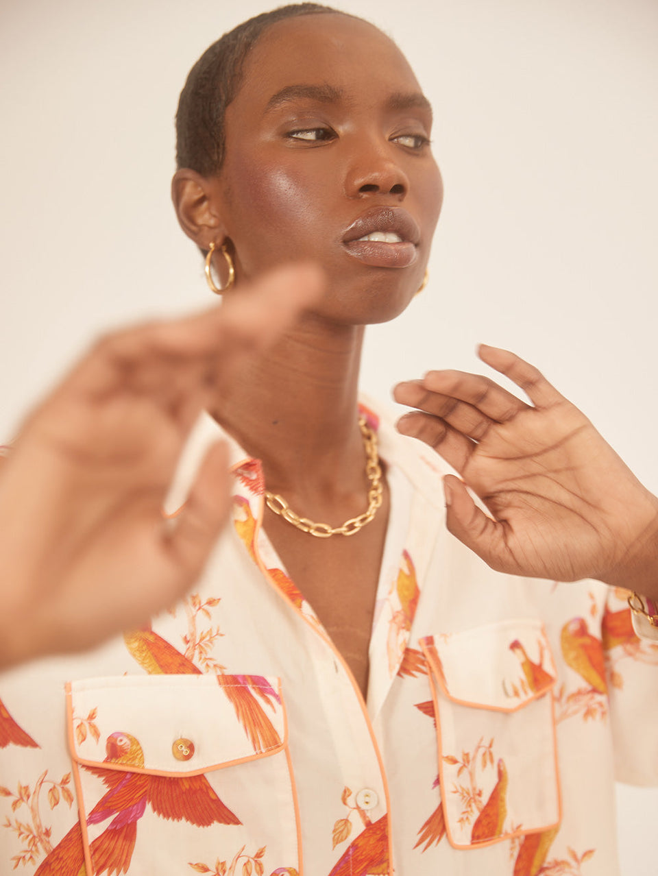 Kaylee Shirt KIVARI | Model wears pink and orange bird printed shirt close up campaign