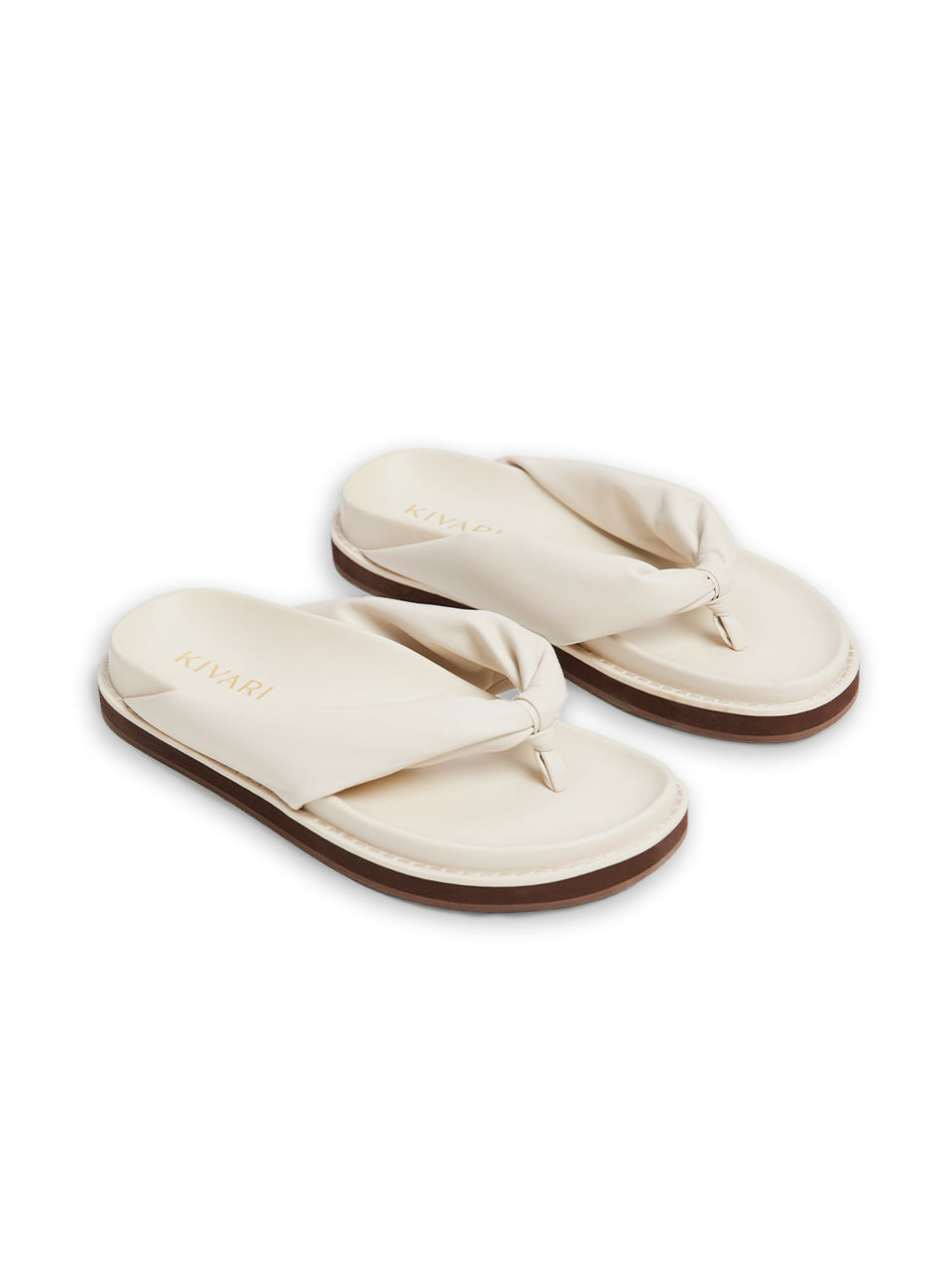 Pair of beige sandals on a white background