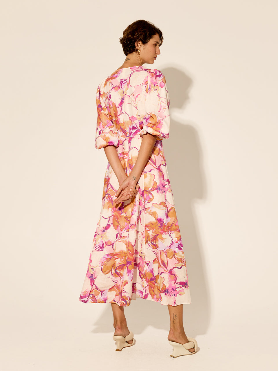 Nadia Maxi Dress KIVARI | Model wears pink and orange watercolour floral maxi dress back view