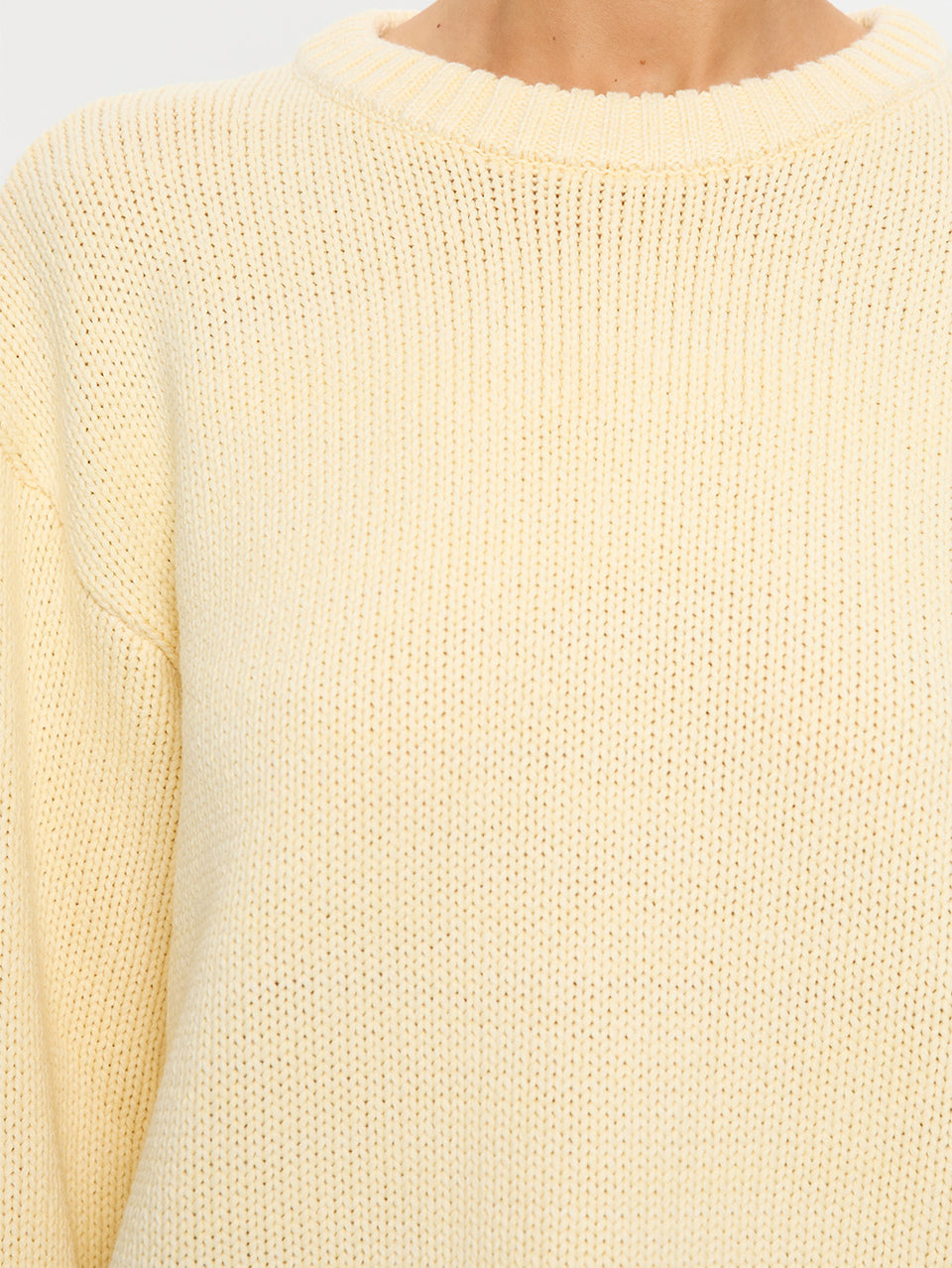 Close-up of a cream-colored sweater with a soft texture