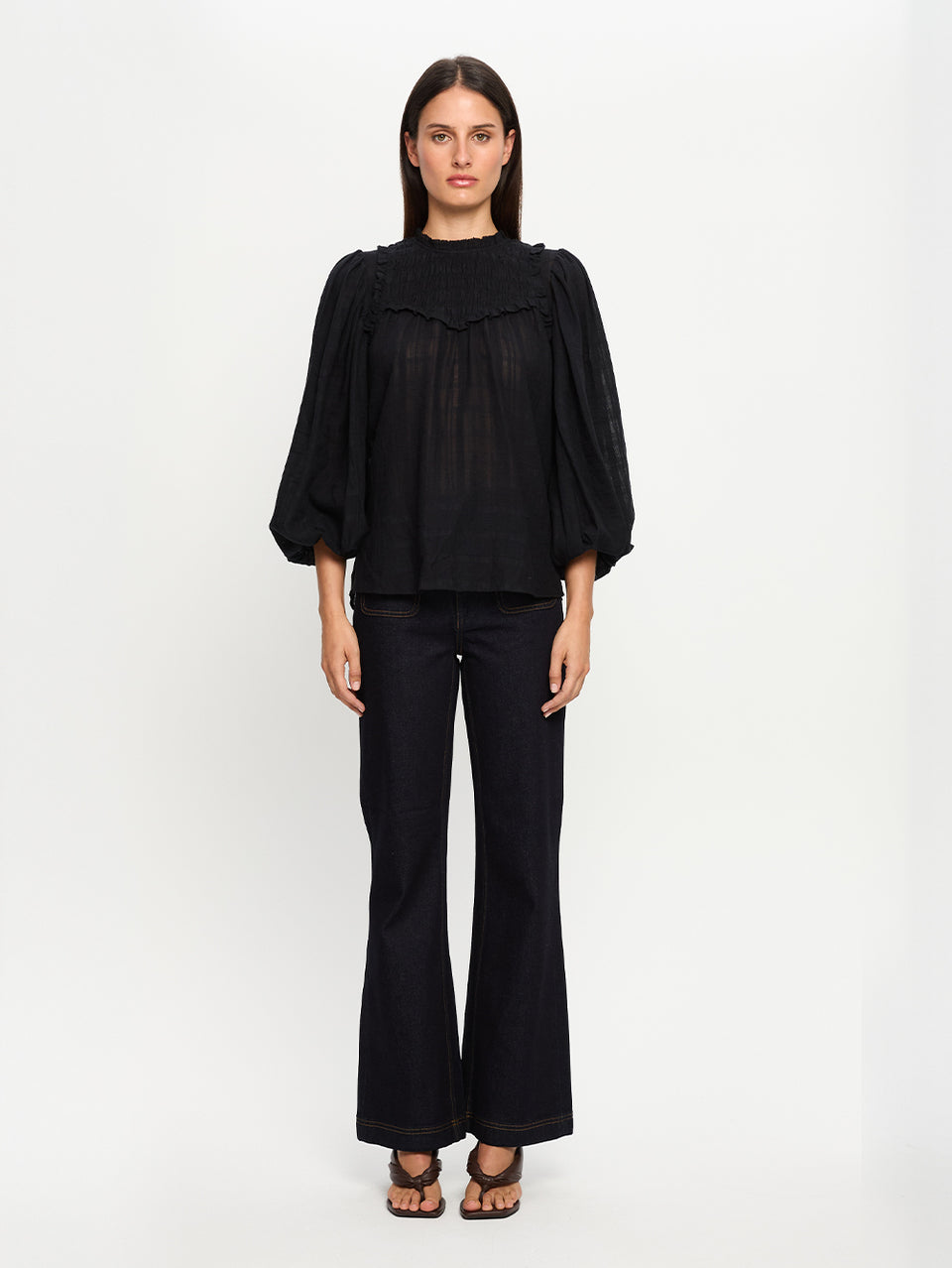 Woman wearing a black outfit on a white background