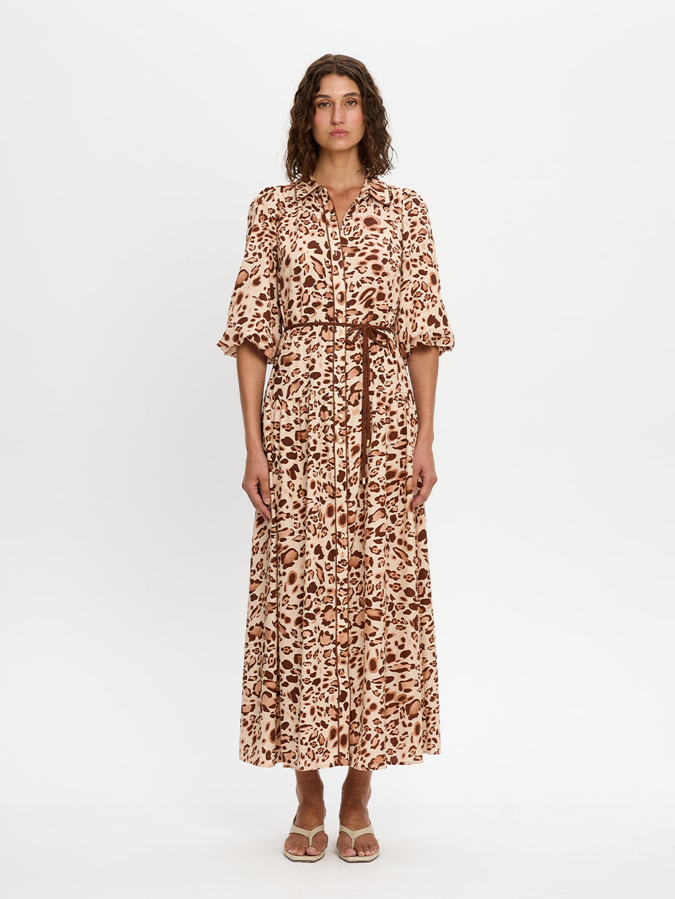 Woman wearing a leopard print dress on a white background