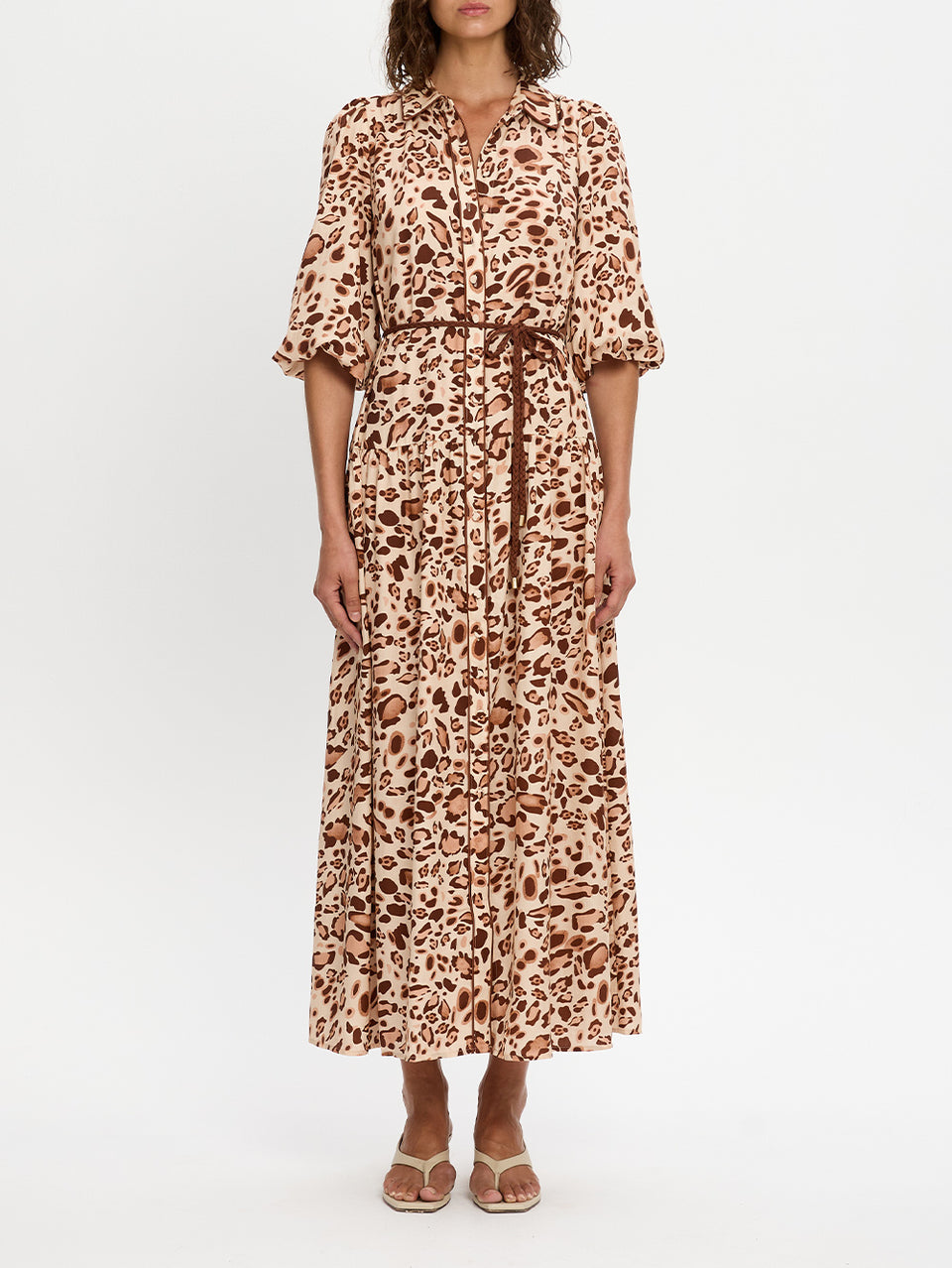 Woman wearing a leopard print dress on a white background