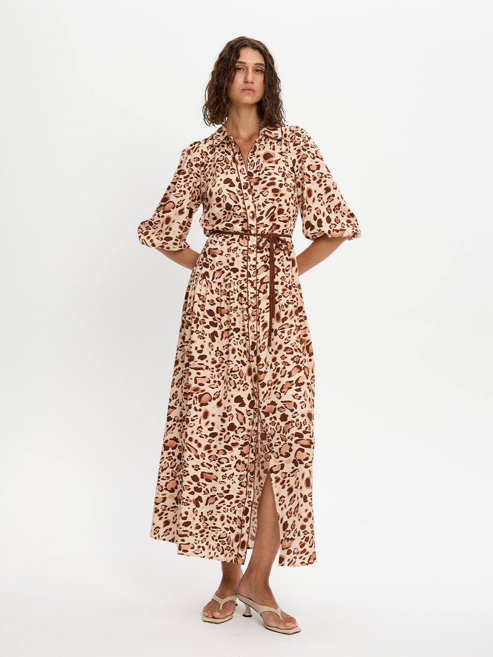 Woman wearing a leopard print dress on a white background