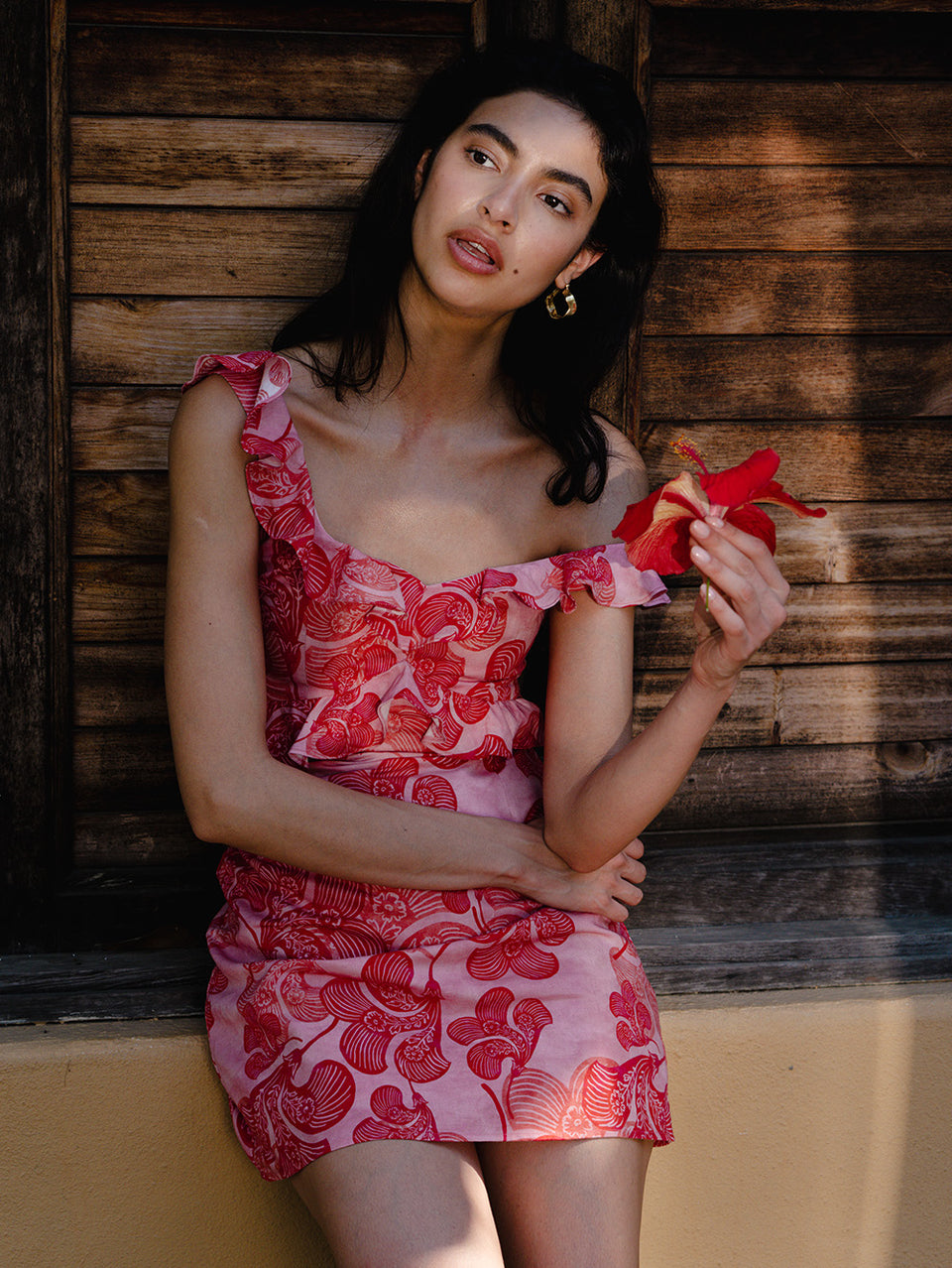 Woman in pink and red floral dress