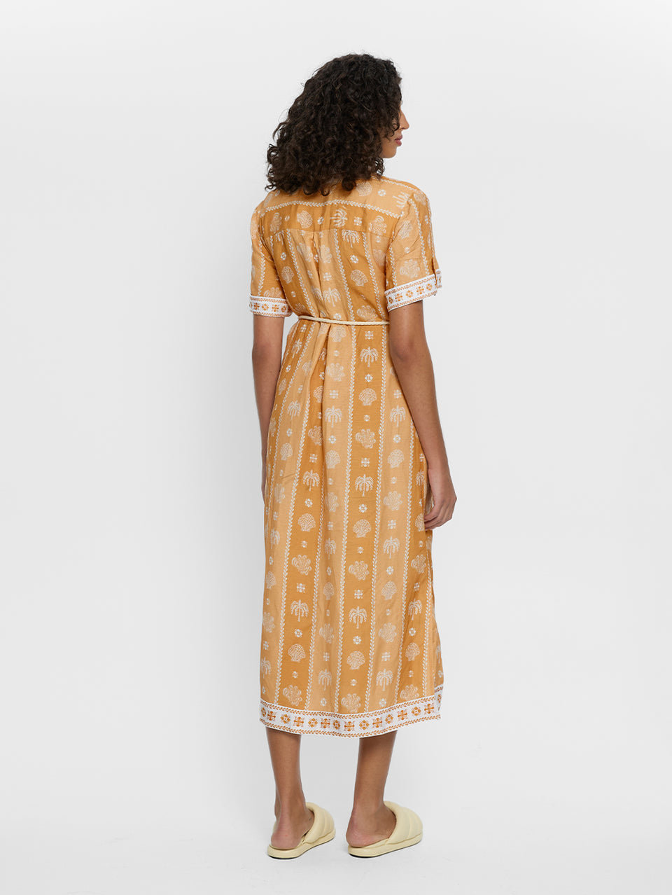 Sienna Midi Dress KIVARI | Model wears orange print midi dress back view