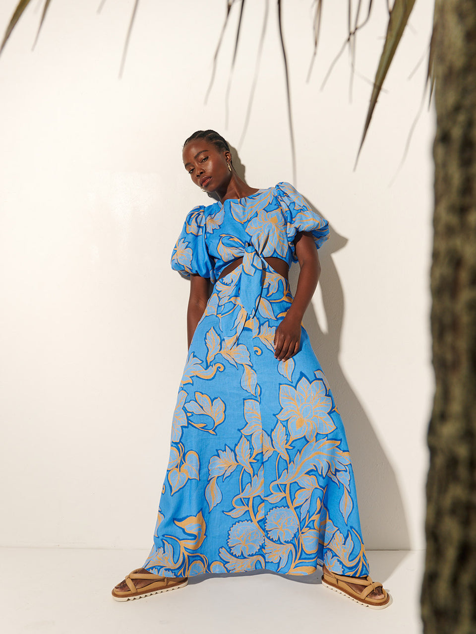 Taniana Cut Out Maxi Dress KIVARI | Model wears blue and orange floral maxi dress next to tree