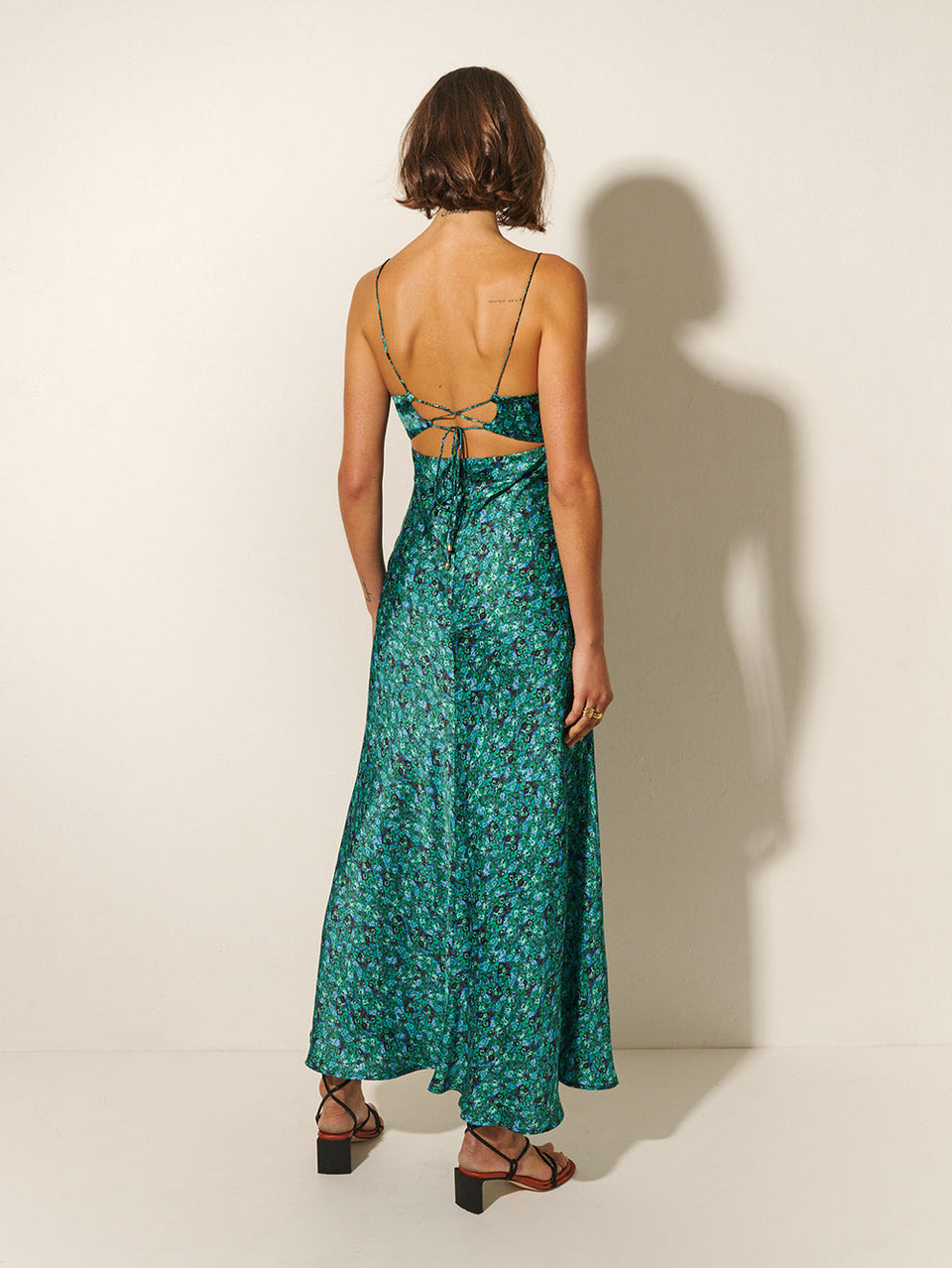KIVARI Acacia Strappy Maxi Dress | Model wears Green Floral Maxi Dress Back View
