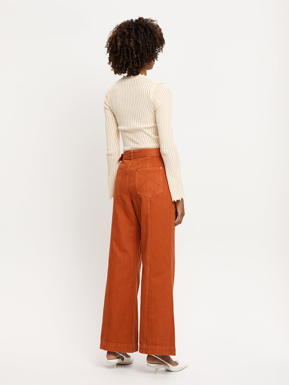 Adele Jean Rust KIVARI | Model wears orange jeans back view