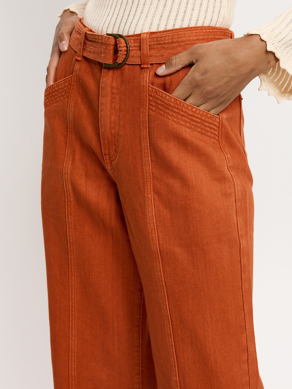Adele Jean Rust KIVARI | Model wears orange jeans close up