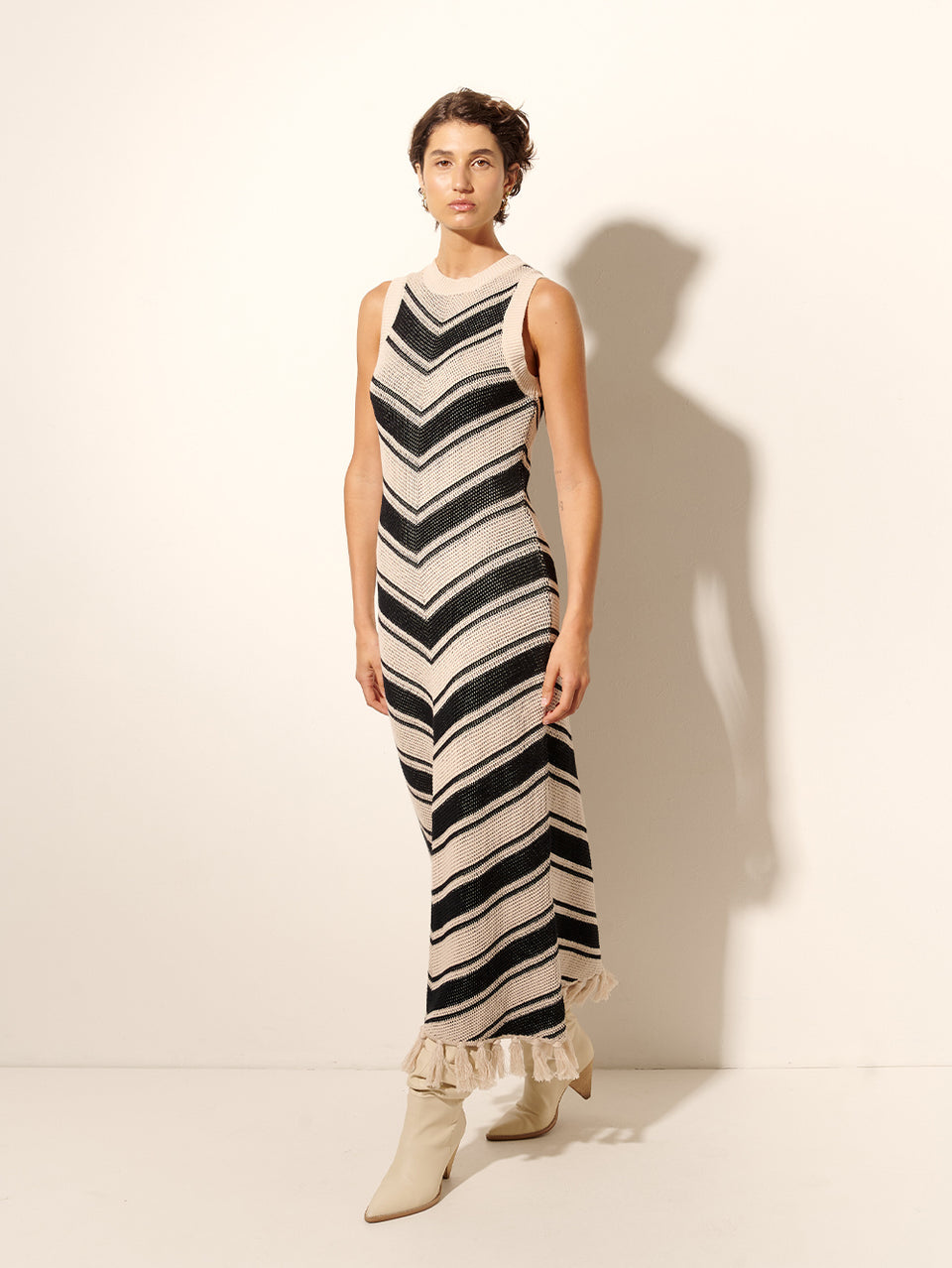 Anita Knit Midi Dress KIVARI | Model wears black and white chevron knit dress side view