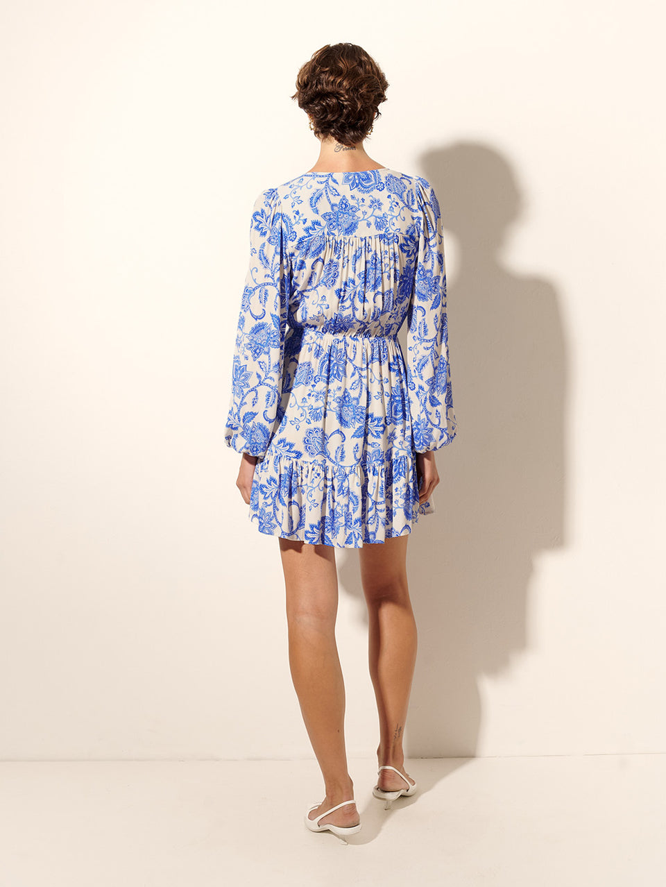 Athena Tie Front Mini Dress KIVARI | Model wears blue and white paisley mini dress back view