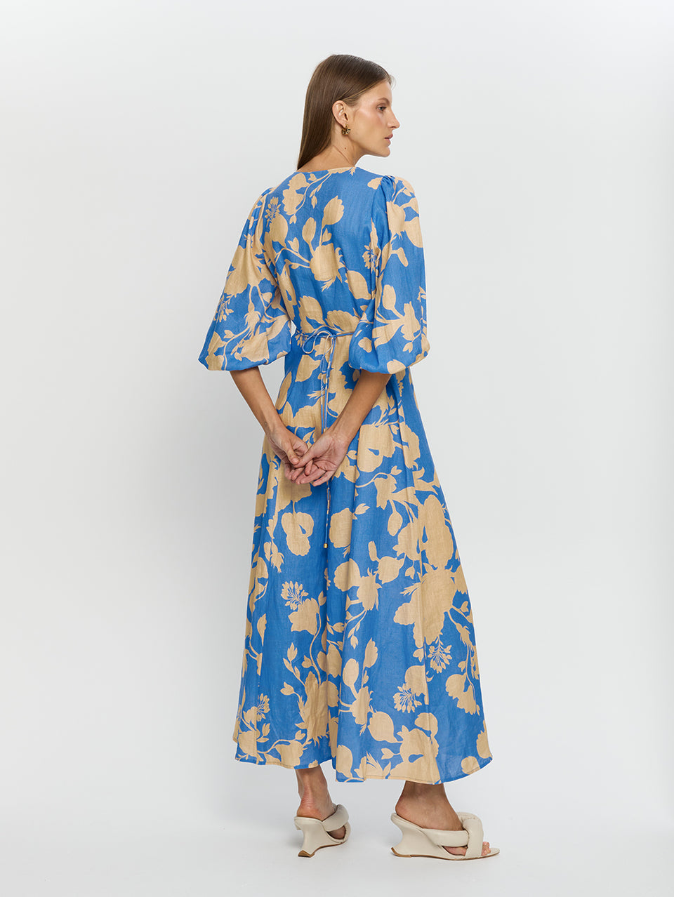 Aurora Maxi Dress KIVARI | Model wears blue floral maxi dress back more