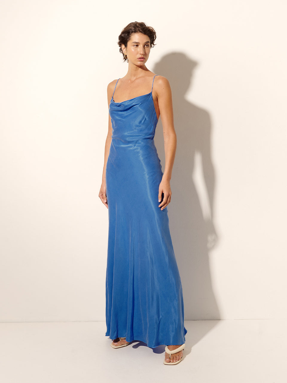 Raya Slip Dress KIVARI | Model wears blue slip maxi dress side view
