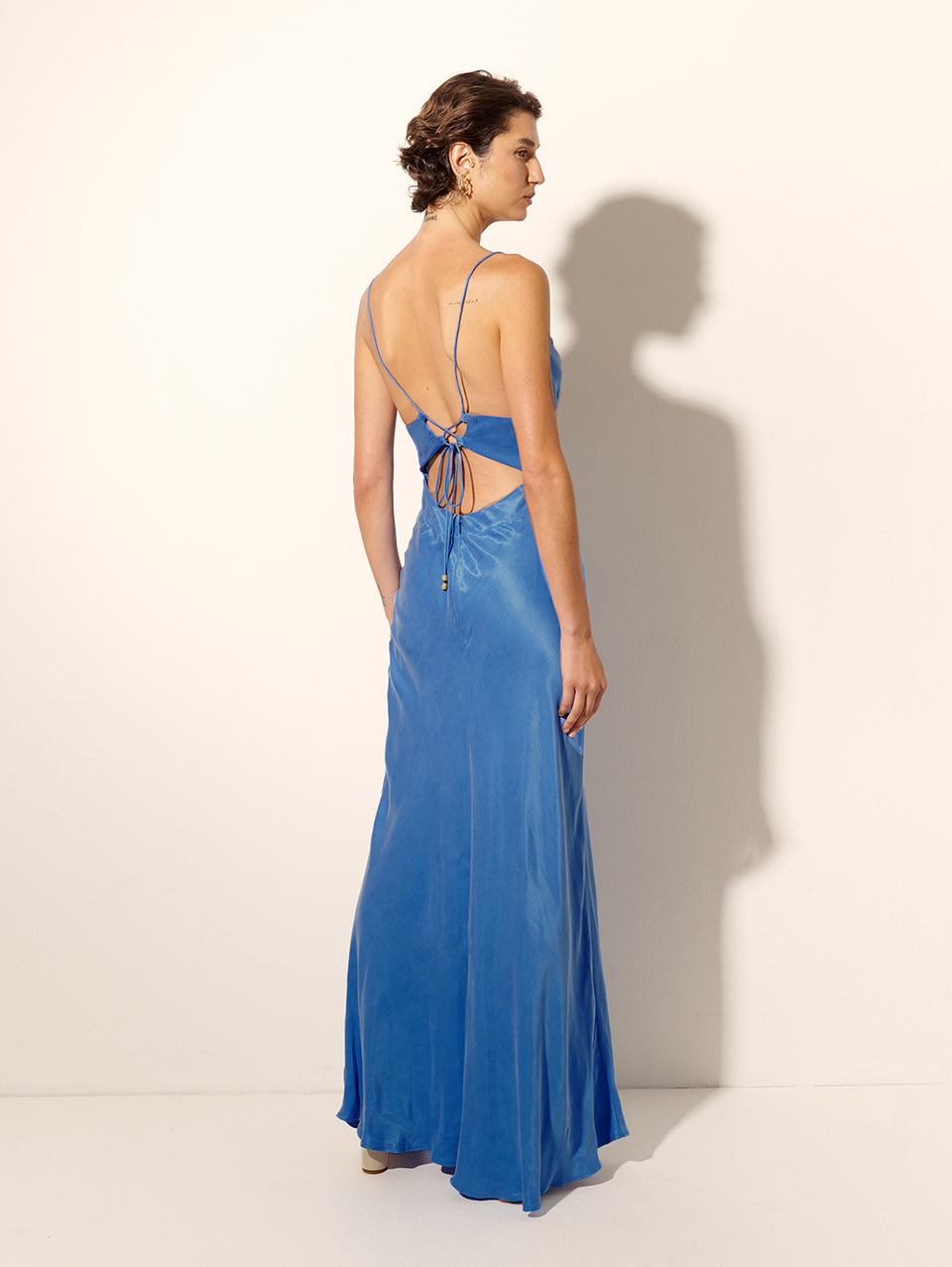 Raya Slip Dress KIVARI | Model wears blue slip maxi dress back view