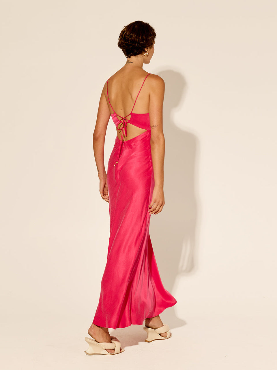 Bianca Slip Dress Pink KIVARI | Model wears hot pink slip dress back view