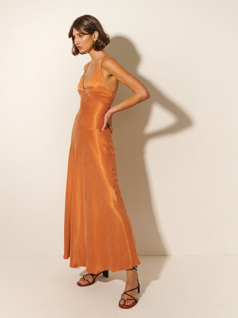 KIVARI Bianca Slip Maxi Dress | Model wears Orange Slip Maxi Dress Side View