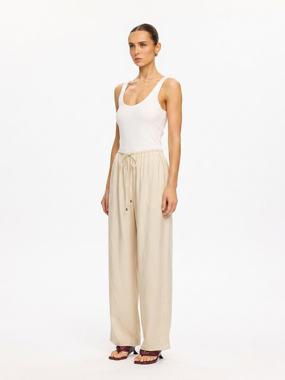 KIVARI Blythe Pant in Champagne – full-length side view of wide-leg pants with white tank top