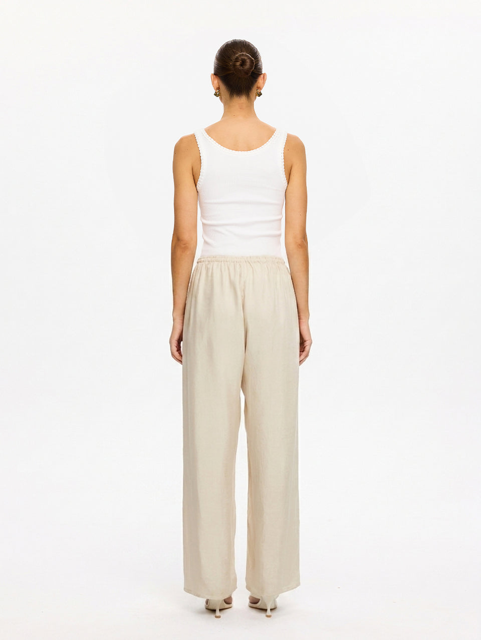 KIVARI Blythe Pant in Champagne – back view of wide-leg pants styled with white tank top