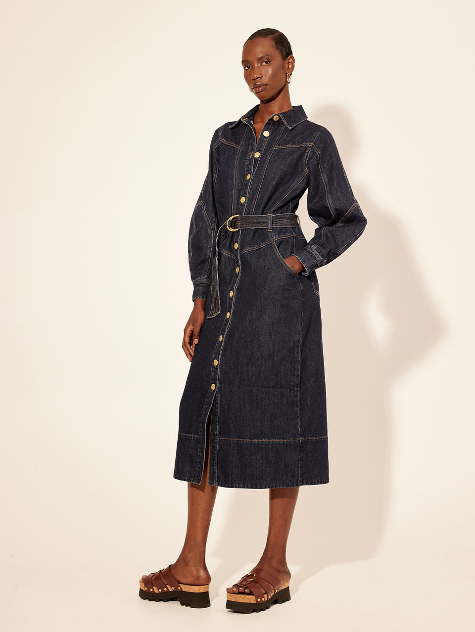 Bonny Midi Dress KIVARI | Model wears navy denim midi dress side view