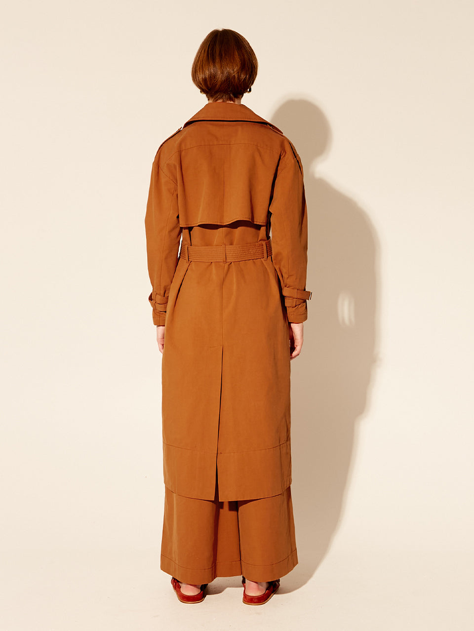 Carolina Trench Coat KIVARI | Model wears burnt orange trench coat back view