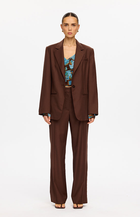 KIVARI categories image - model wearing brown oversized blazer with matching wide-leg trousers and blue floral top