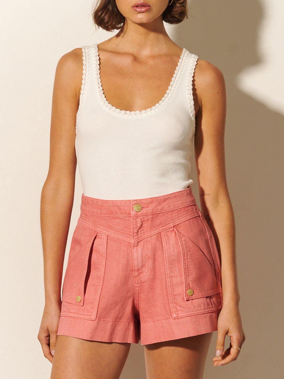 Celene Short KIVARI | Model wears pink denim shorts close up