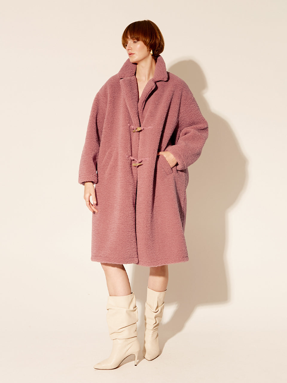 Clara Coat KIVARI | Model wears pink fluffy coat side view