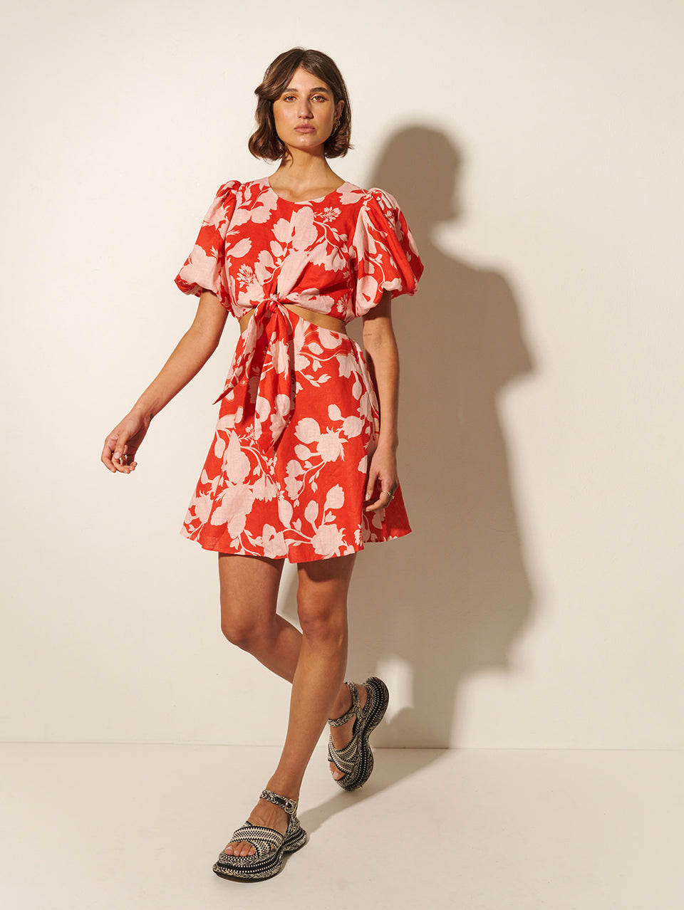 Delfina Mini Dress KIVARI | Model wears pink and red floral mini dress