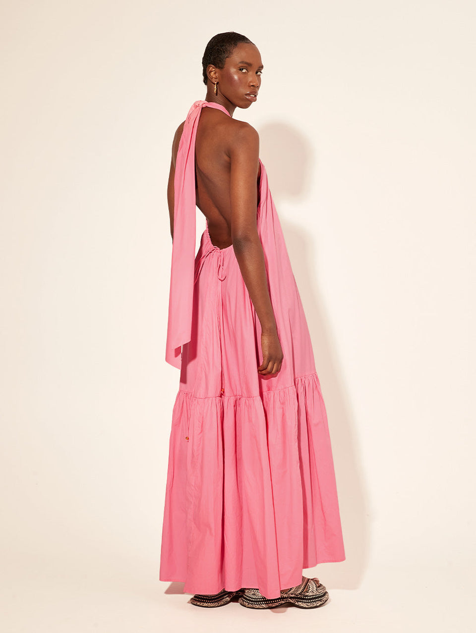 KIVARI Dua Halter Dress | Model wearing Pink Halter Neck Dress Back View