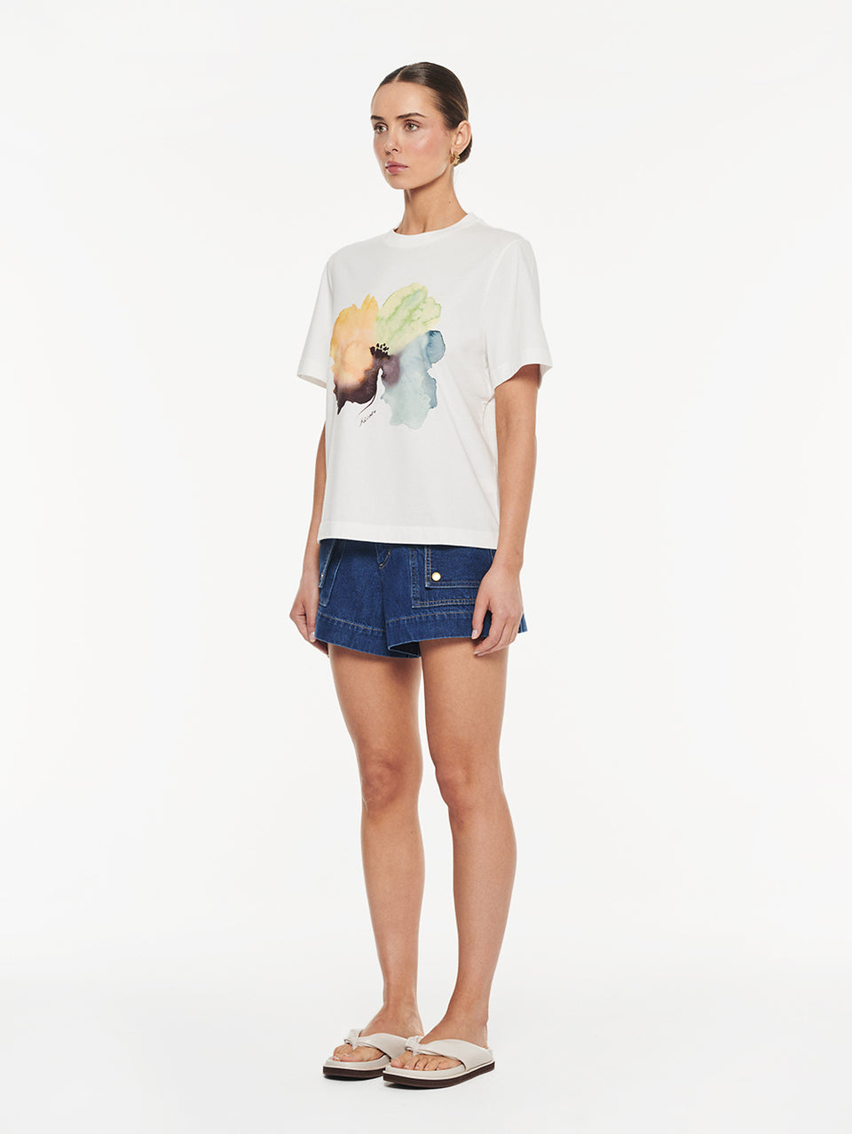 Lotte Tee in Yellow print, graphic t-shirt with watercolor print styled with denim shorts and slide sandals
