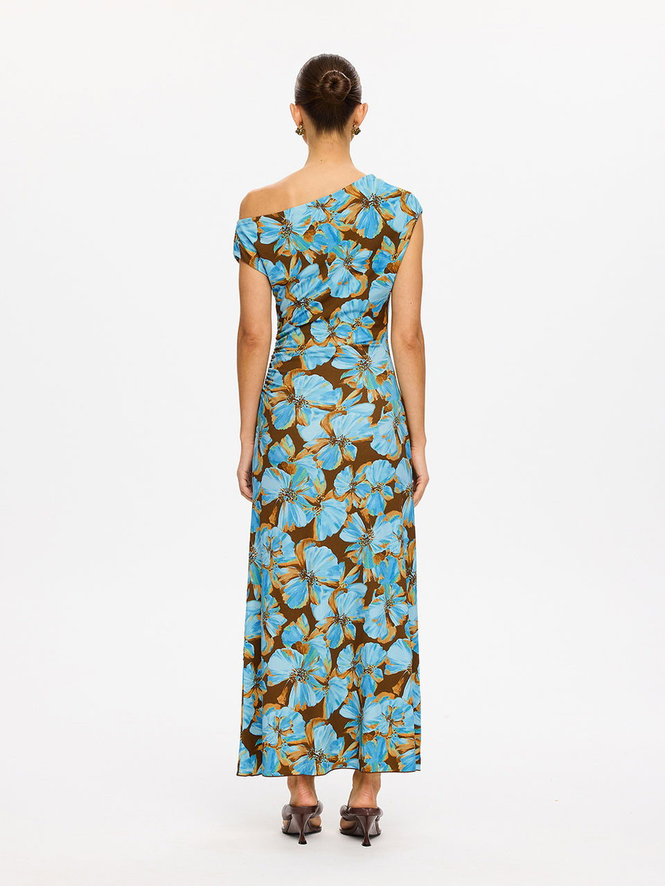 KIVARI Nieve Jersey Maxi Dress in Blue - back view of model wearing blue and brown floral one-shoulder jersey maxi dress