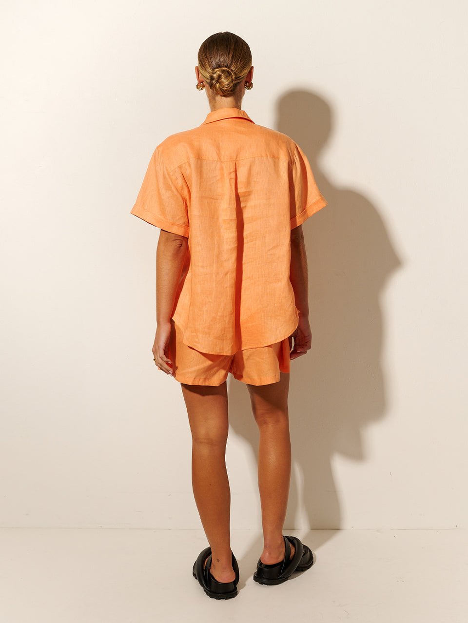 KIVARI Eve Shirt | Model wearing Orange Shirt Back View
