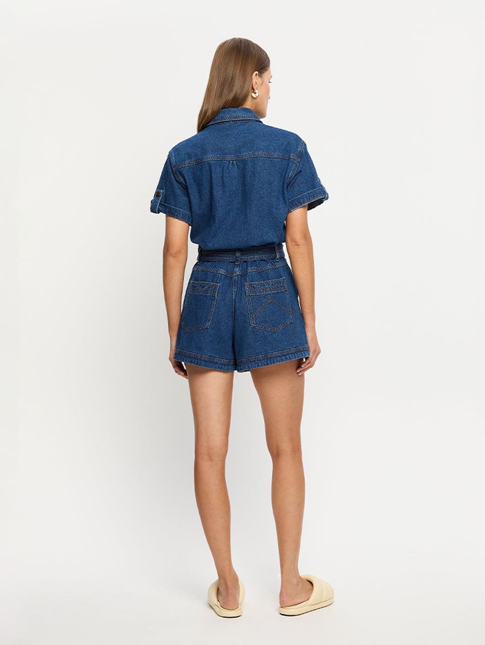 Georgie Denim Indigo KIVARI | Model wears indigo blue denim playsuit back view