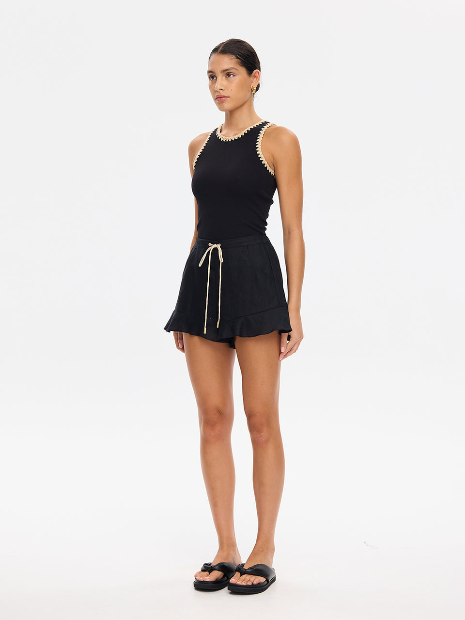 KIVARI Azarea black tank top and shorts set, angled front view with slide sandals