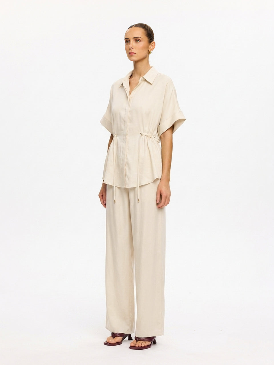 KIVARI Jaxon Shirt in Champagne – side angle view of collared shirt with matching wide-leg trousers