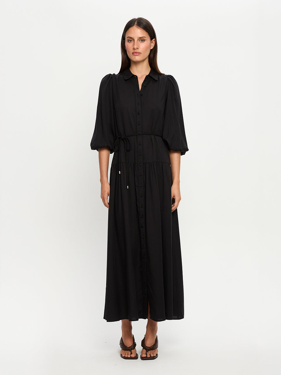 Woman wearing a black dress on a white background