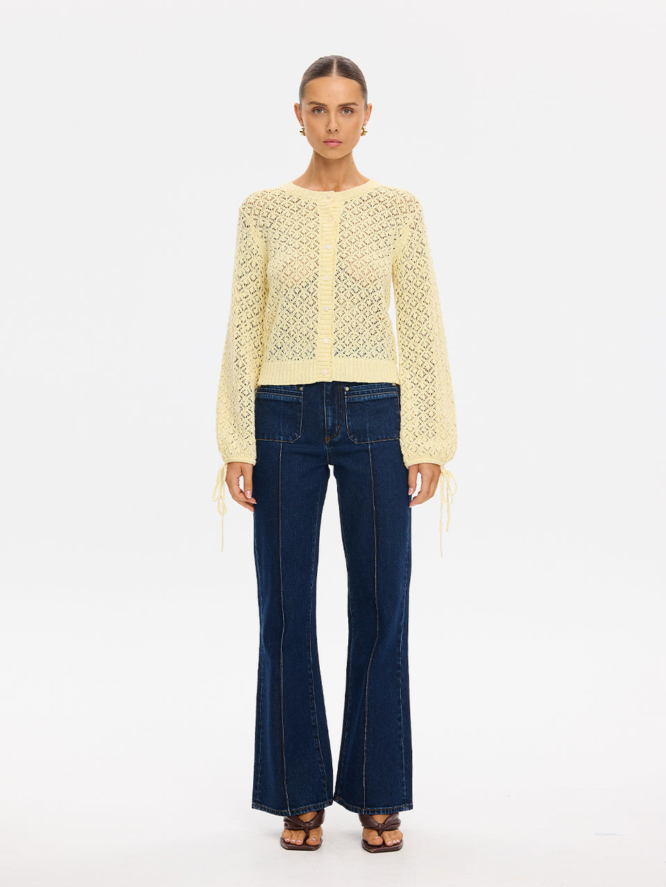 Sally Knit Cardigan in Butter yellow, open-knit long-sleeve cardigan styled with flared denim jeans and sandals