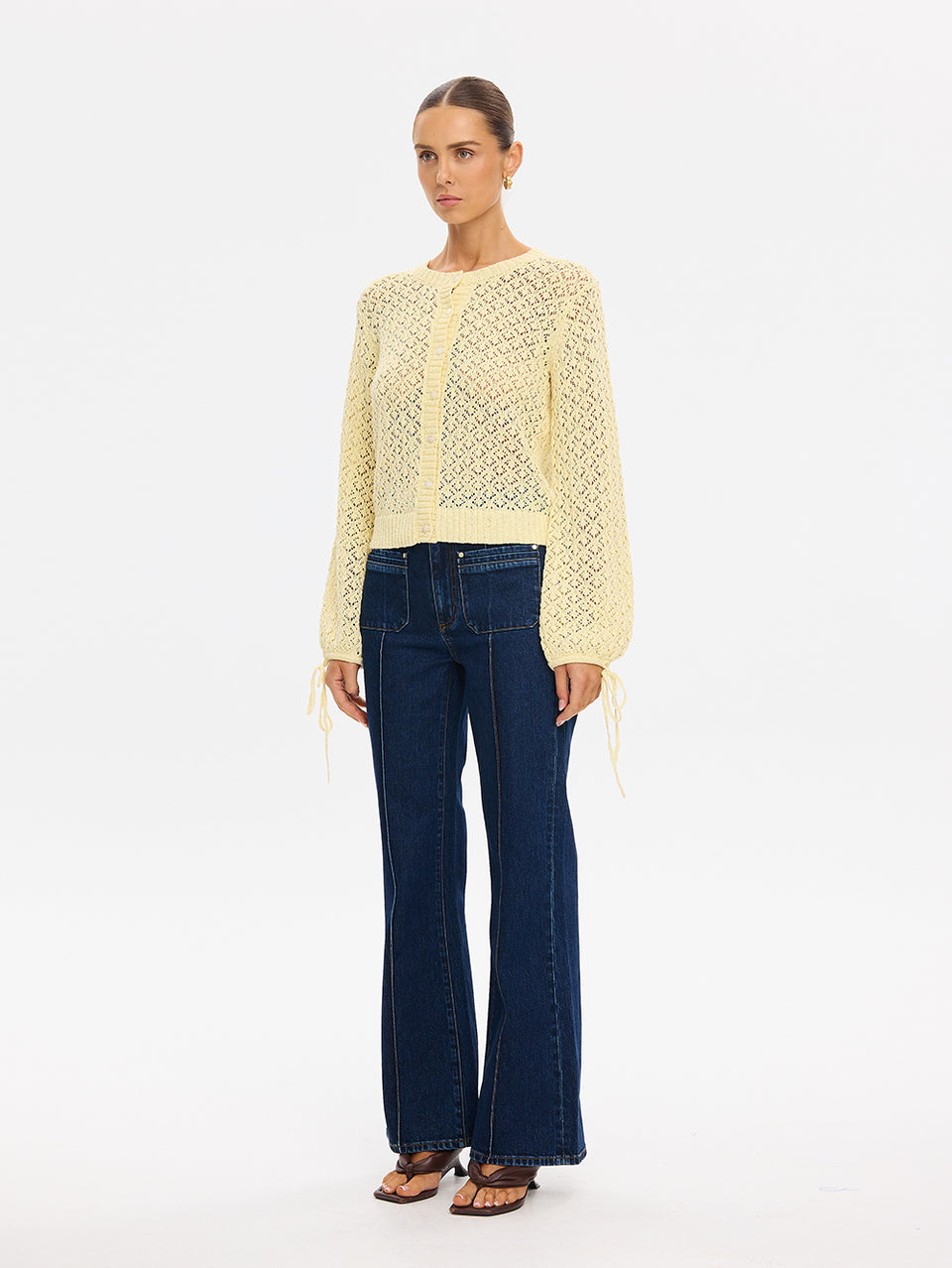 Sally Knit Cardigan in Butter yellow, open-knit long-sleeve cardigan with tie cuffs, styled with wide-leg jeans and sandals