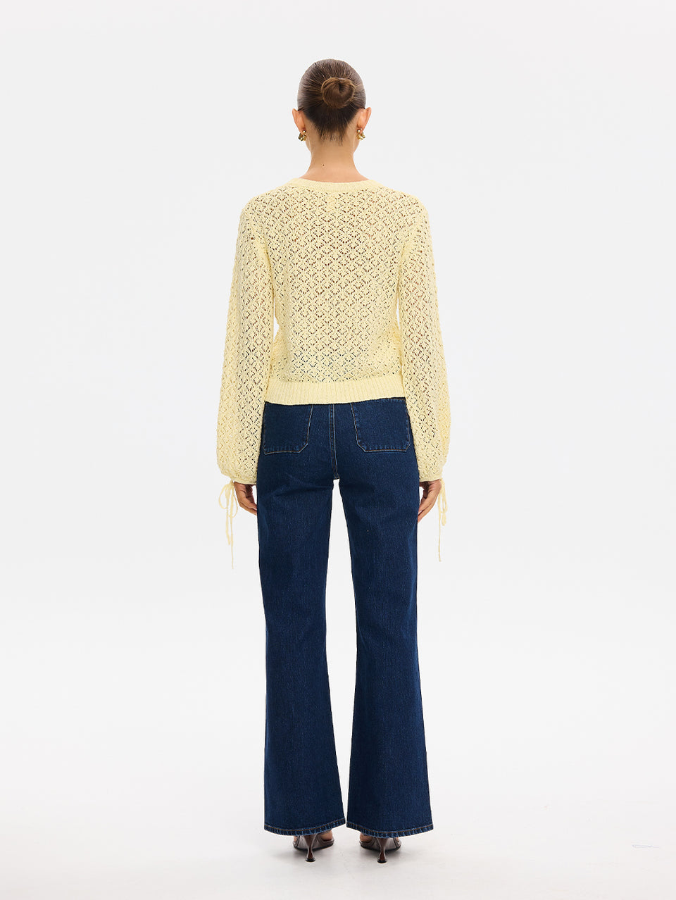 Sally Knit Cardigan in Butter yellow, back view of open-knit long-sleeve cardigan with wide-leg denim jeans