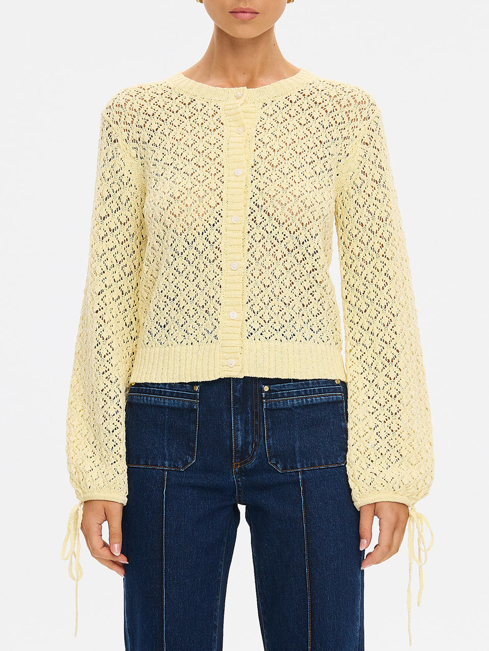 Sally Knit Cardigan in Butter yellow, close-up of open-knit cropped cardigan with button front and tie cuffs