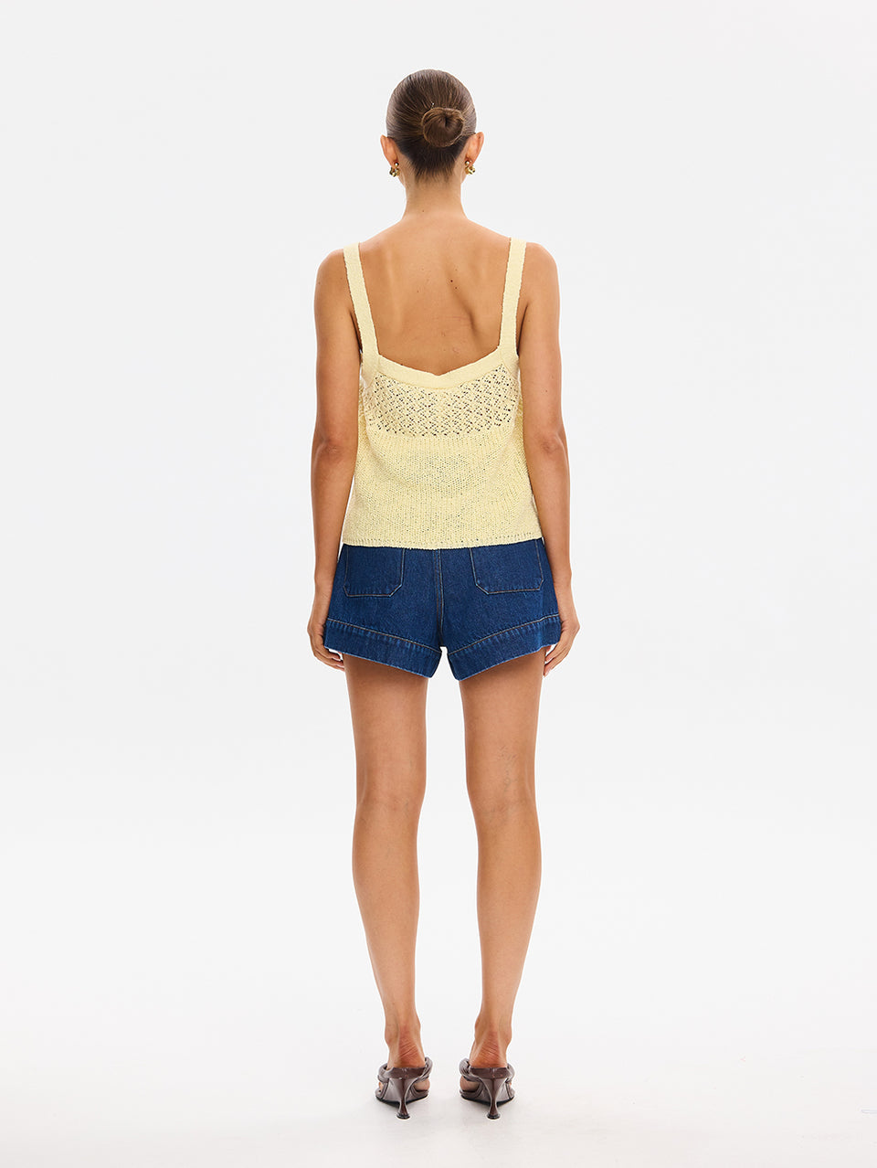 Sally Knit Cami in Butter yellow, back view of crochet knit tank top with denim shorts