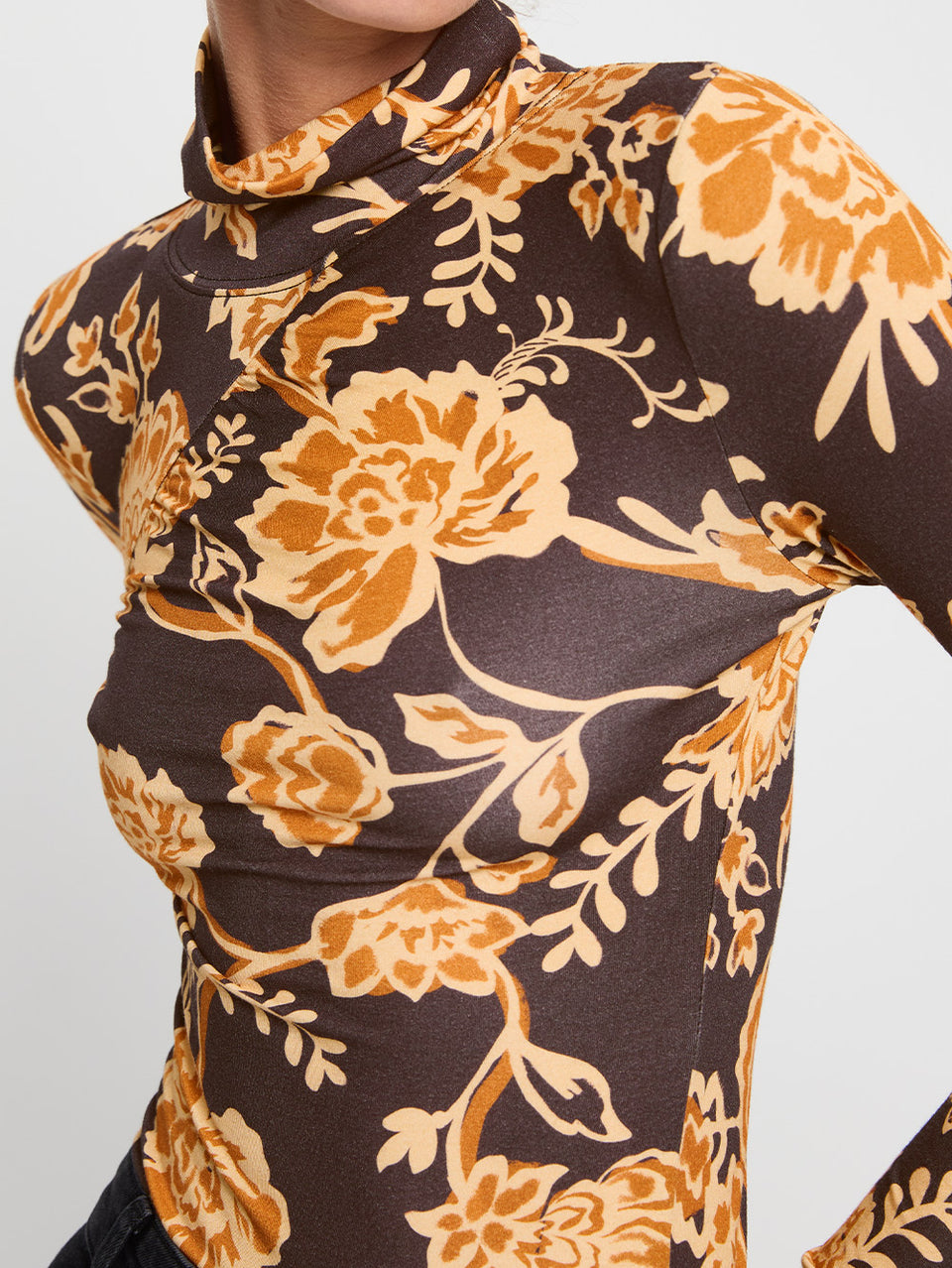 Kaia Skivvy KIVARI | Model wears black and orange floral skivvy close up