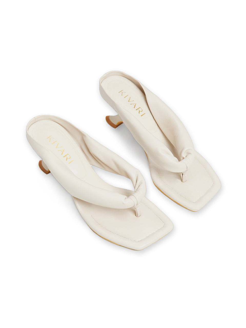 Pair of cream-colored sandals with a knot design on a white background