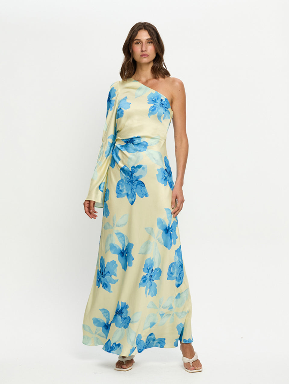 Woman wearing a floral dress with blue flowers on a white background