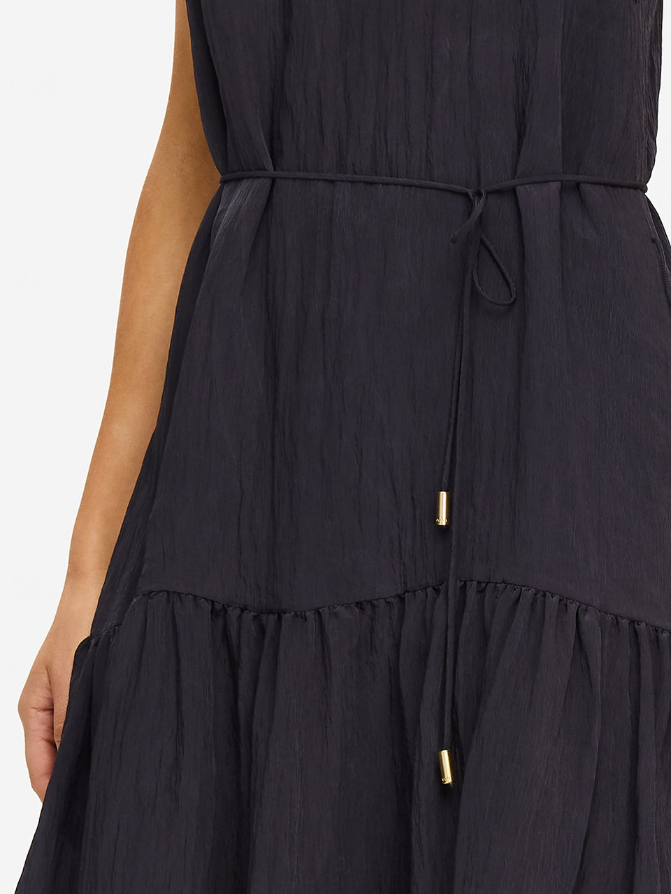 KIVARI Umi Maxi Dress in Charcoal – close-up detail of drawstring waist with gold hardware on women's charcoal tiered maxi dress