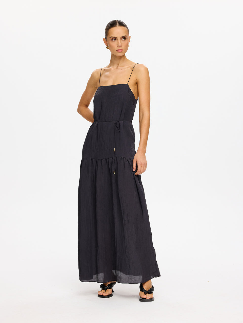 KIVARI Umi Maxi Dress in Charcoal – full-length front view showing tiered maxi skirt, model wearing women's charcoal spaghetti strap maxi dress